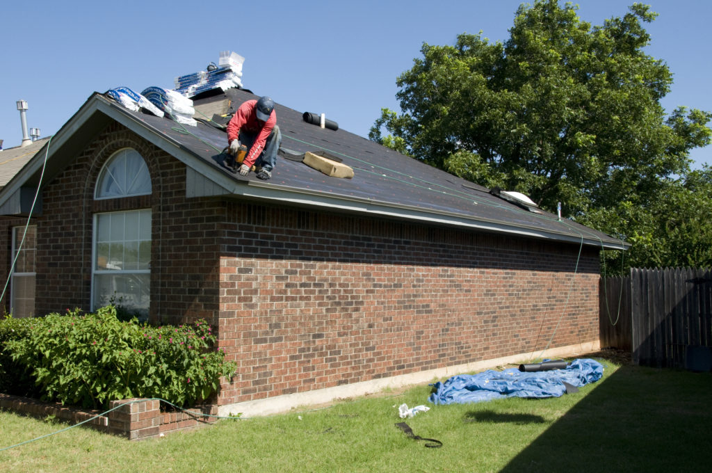 Roofer working on house